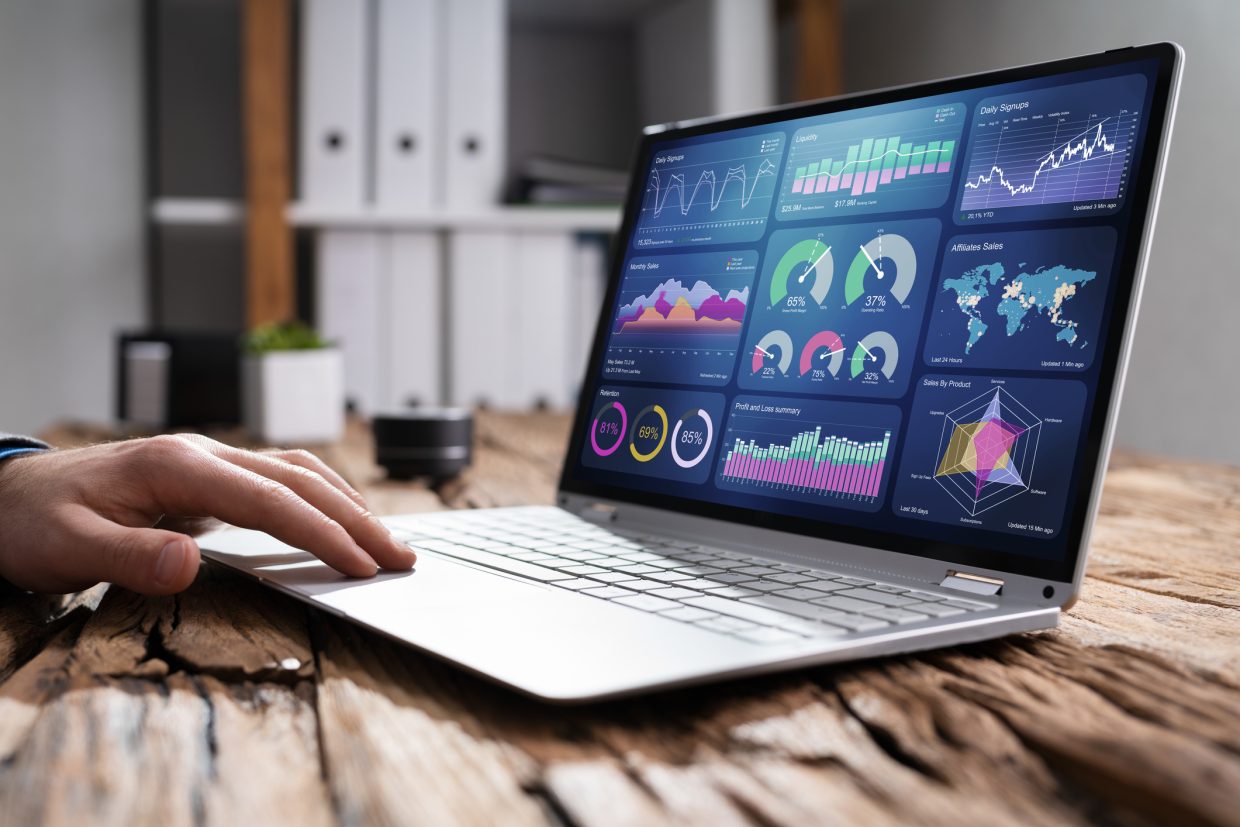 A laptop showing a dashboard on screen with various metrics and charts to reflect performance. Represents data analytics.